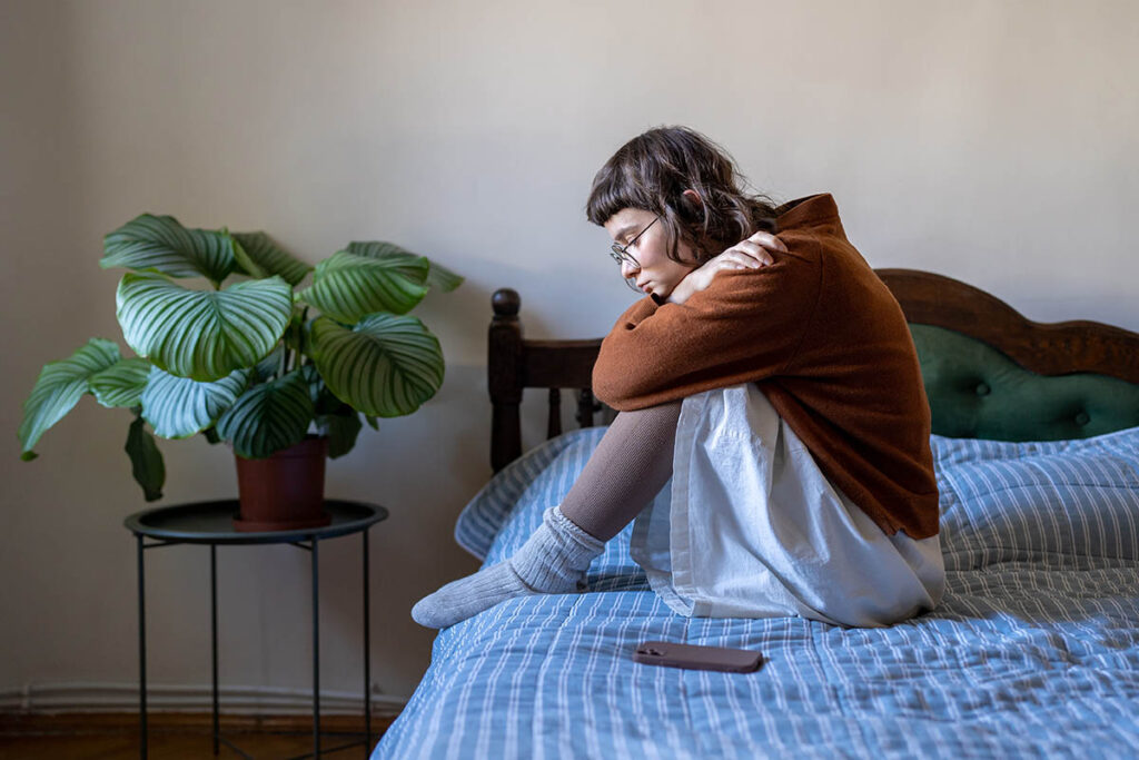 teen sitting on bed wondering how common is anxiety in teens
